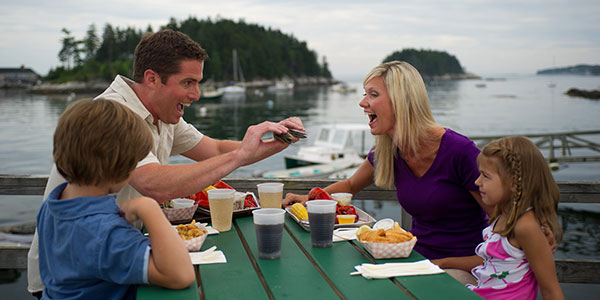 Family Eating Clams and Lobster in Maine